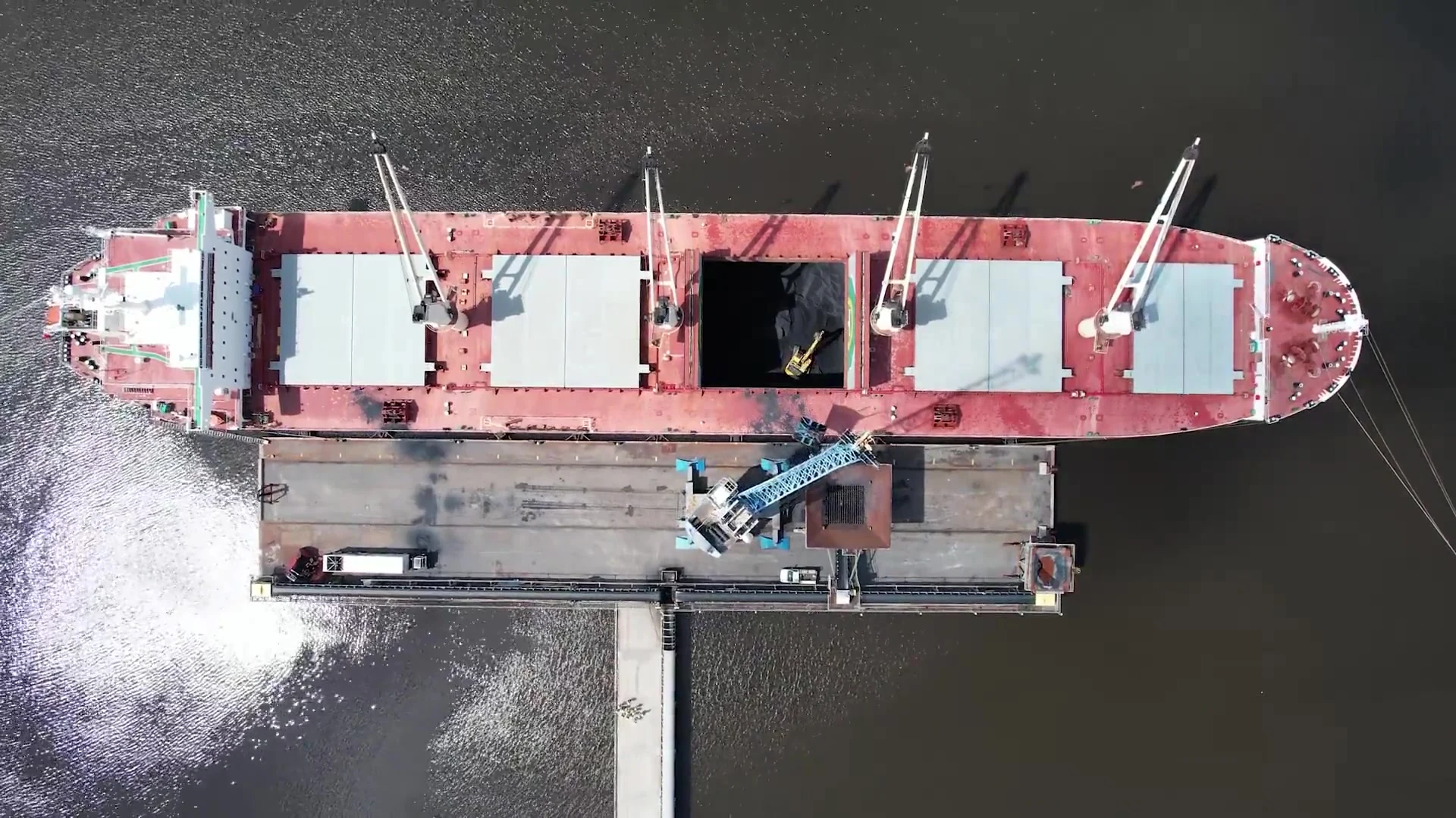 A dry bulk carrier alongside a loading terminal